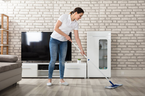 Woman Cleaning Hardwood Floor - Фото, зображення