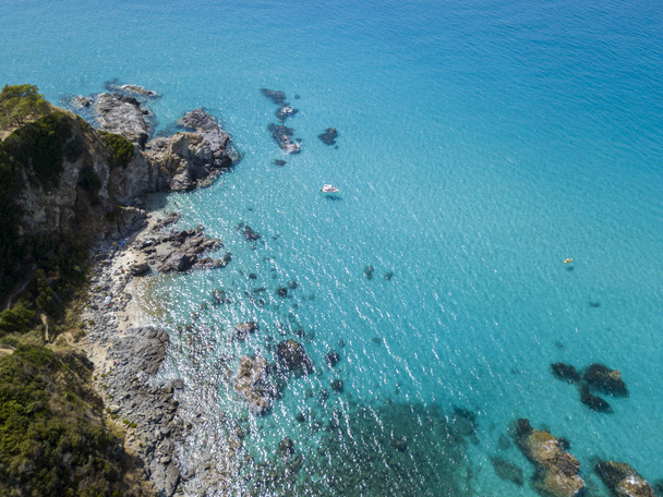 Paradise of the sub, beach with promontory overlooking the sea. Zambrone, Calabria, Italy. Diving relaxation and summer vacations. Italian coasts, beaches and rocks. Aerial view - Photo, Image