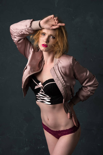 Redhead in pink and black - Фото, изображение