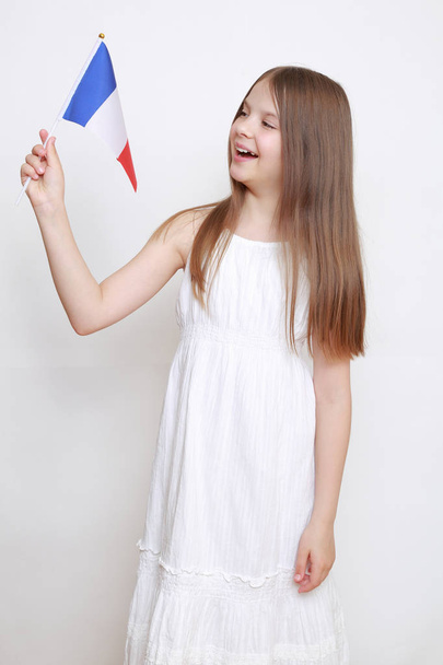 Lovely european little girl holding French flag - Photo, Image