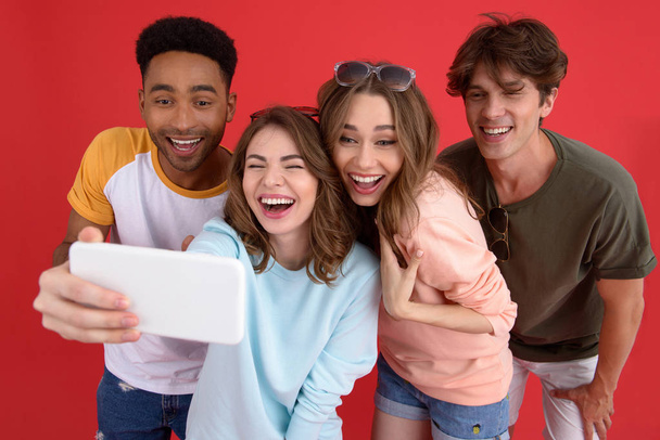 Cheerful group of friends make selfie by phone. - Photo, Image