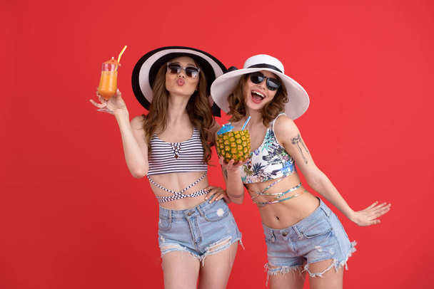 Happy two women drinking cocktails. - Фото, изображение