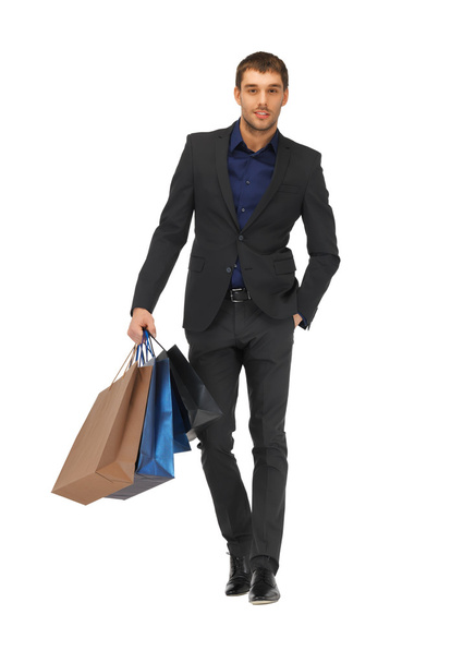 Handsome man in suit with shopping bags - 写真・画像