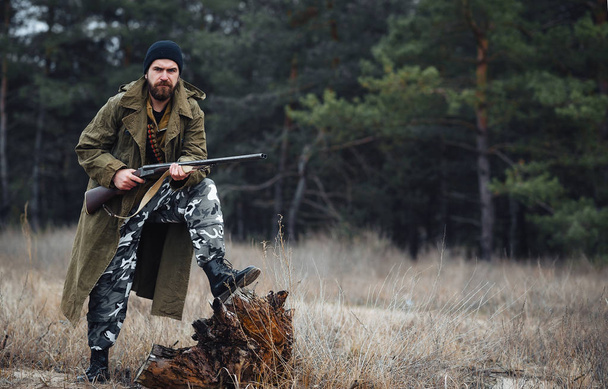 Brodaty hunter w profesjonalny sprzęt spaceru w lesie - Zdjęcie, obraz