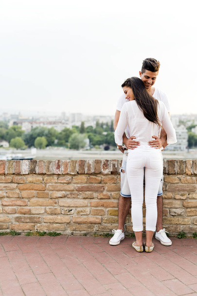 Young couple holding each other around waist - Foto, Imagen