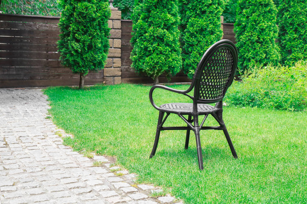 Comfortable chair on green grass near sidewalk in park - Foto, immagini