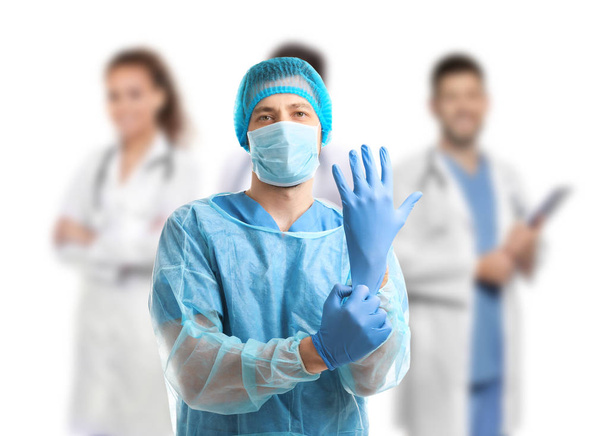 Surgeon with medical staff on white background - Foto, imagen