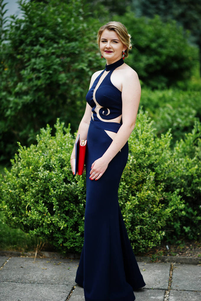 Portrait of an attractive young woman graduate in fancy dress po - Φωτογραφία, εικόνα