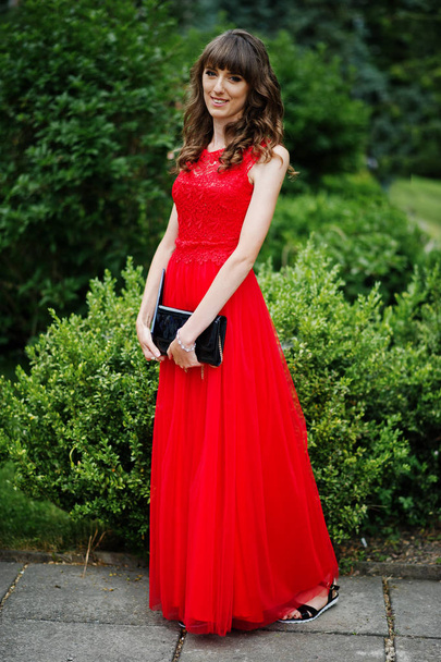 Portrait of an attractive young woman graduate in fancy dress po - Foto, afbeelding