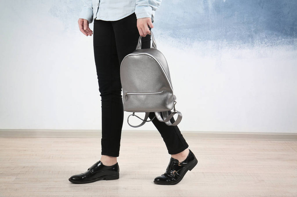 Woman holding leather backpack - Foto, afbeelding