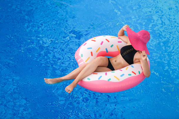 Beautiful young girl with inflatable donut  - Φωτογραφία, εικόνα