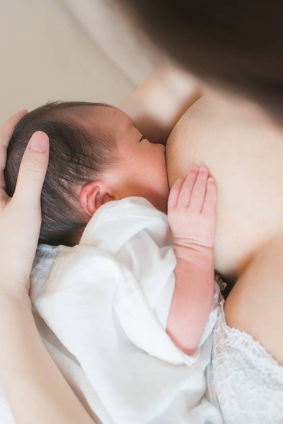Mother breast feeding and hugging her baby. - Фото, зображення