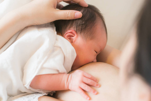Mother breast feeding and hugging her baby. - Valokuva, kuva