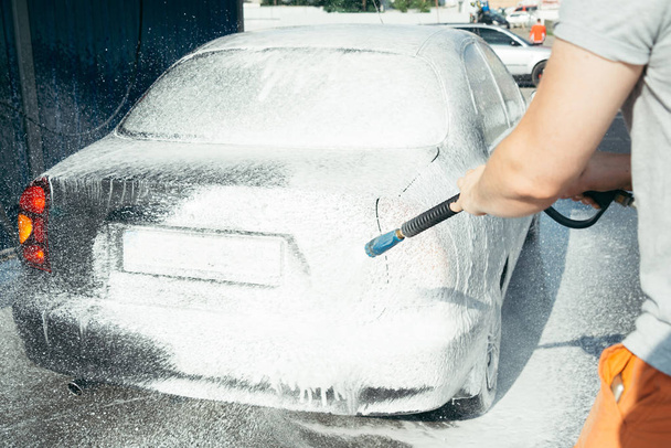lavagem de carro à mão usando uma preparação de espuma para polir, carros em uma carwash
 - Foto, Imagem