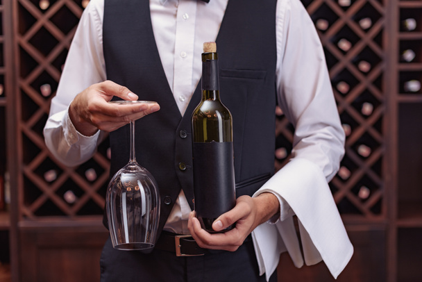 sommelier with wine and glass - Фото, зображення