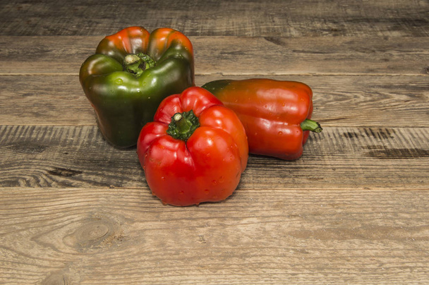 A few peppers on a wooden table - Foto, Imagem