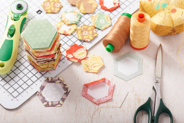 English paper pieced hexagons on white craft mat - 写真・画像
