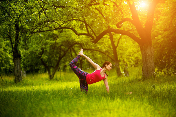 Practicing yoga asanas in nature. - Foto, Imagen
