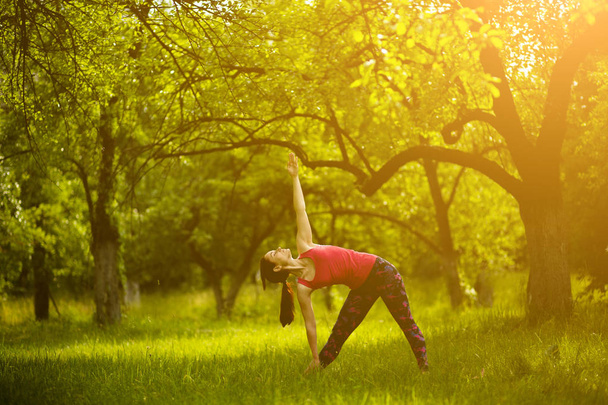 Girl doing yoga asana extended triangle. - Photo, image