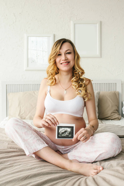 Beautiful adult pregnant woman. Waiting for the baby. Pregnancy. Care, tenderness, motherhood, childbirth. - Photo, Image