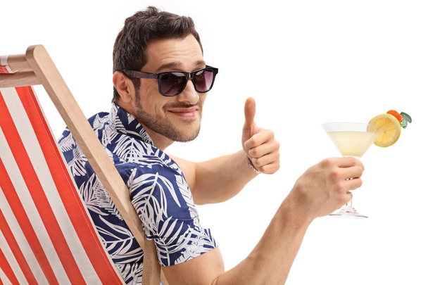 Tourist with a cocktail making a thumb up gesture - 写真・画像