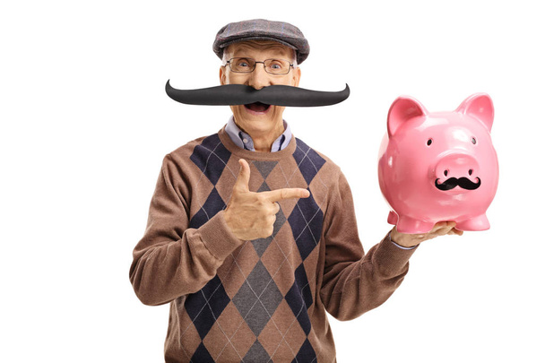man with fake moustache pointing at a piggybank - Foto, afbeelding