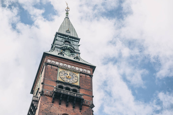 Tower with clock in the city hall in Copenhagen against the blue - Foto, imagen