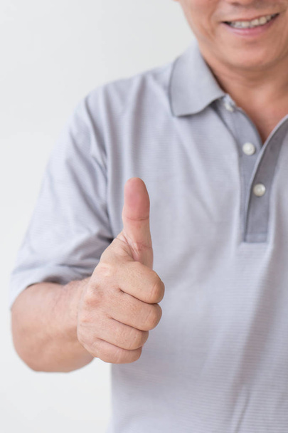 счастливый, успешный, позитивный мужчина средних лет, показывающий большой палец вверх
 - Фото, изображение