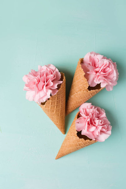 Pink flowers in waffle cones - Фото, зображення