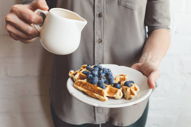 woman pouring syrup on tasty waffles - Photo, Image