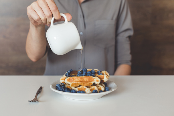 woman pouring syrup on tasty waffles - Photo, Image