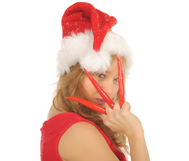 Attractive young woman in Santa Cap with chili pepper. isolated on white - Φωτογραφία, εικόνα