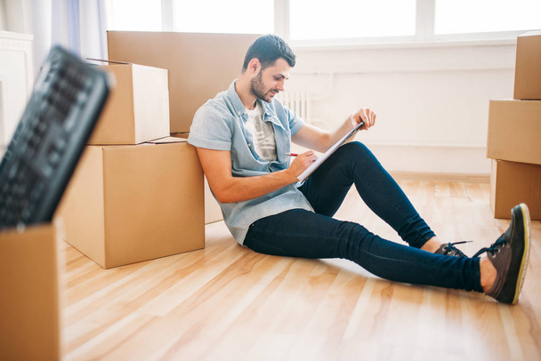 man sitting near cardboard boxes - Photo, Image