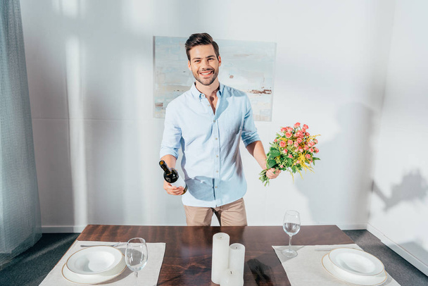 man with bouquet of flowers and wine - Fotoğraf, Görsel