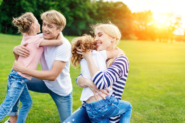family hugging in park - Photo, Image