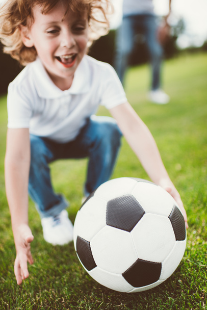 boy playing soccer in park - Фото, изображение