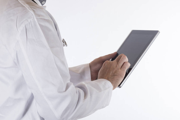 Doctor in a lab coat using a tablet computer - Photo, Image