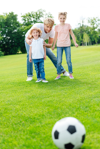 father with kids playing soccer - Фото, изображение