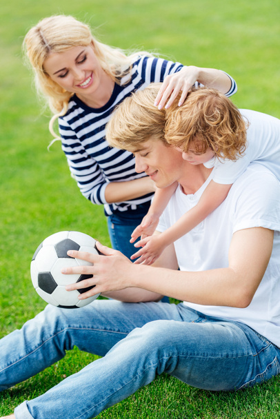 family with soccer ball playing in park - Foto, Imagen