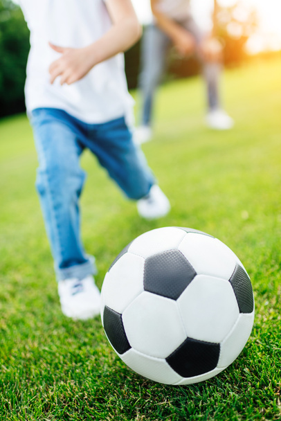 boy playing soccer in park - Photo, Image