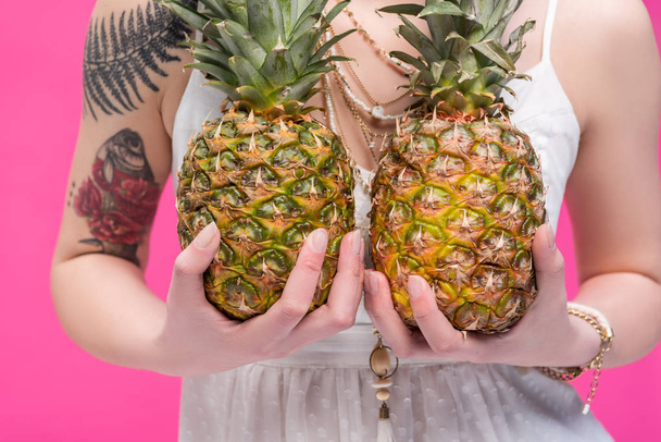 young woman holding pineapples - Фото, изображение