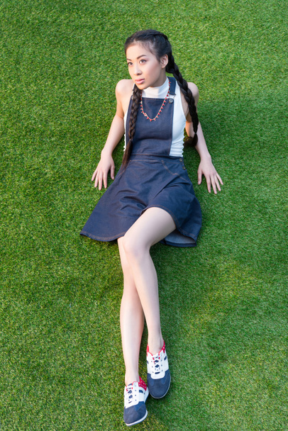asian girl lying on grass - Фото, изображение