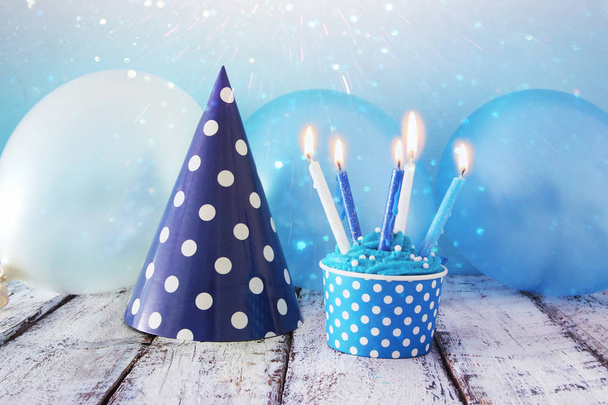 Birthday concept with cupcake and candles on wooden table. - Фото, изображение