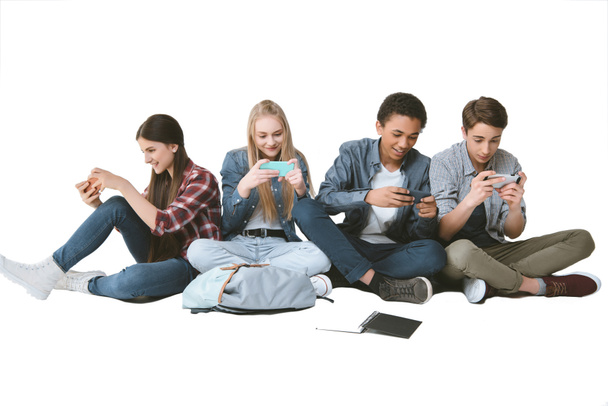 multicultural teenagers using smartphones - Photo, Image