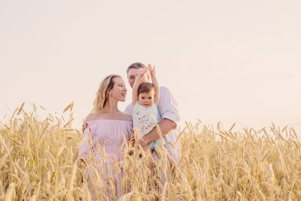 happy family in cereal field at sunset - 写真・画像