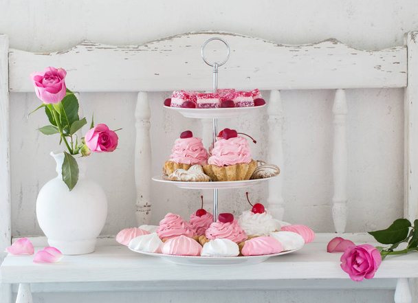 pink cakes on plate on white background - Foto, Imagen