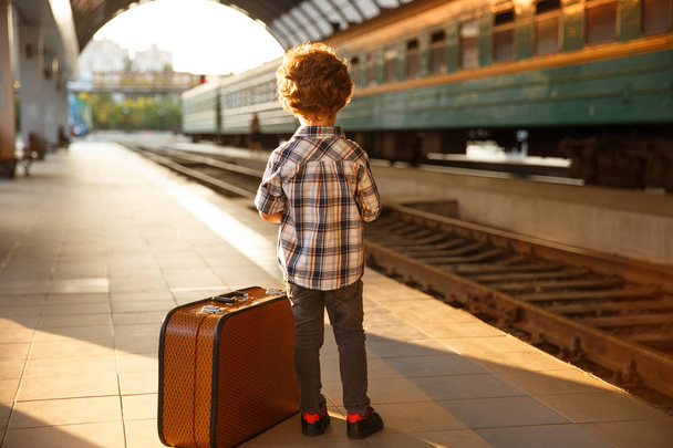 Stylish kid with luggage on train station - Fotoğraf, Görsel