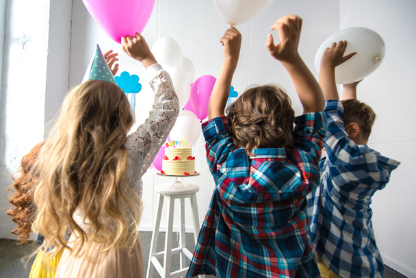 kids reaching to birthday cake - Photo, Image