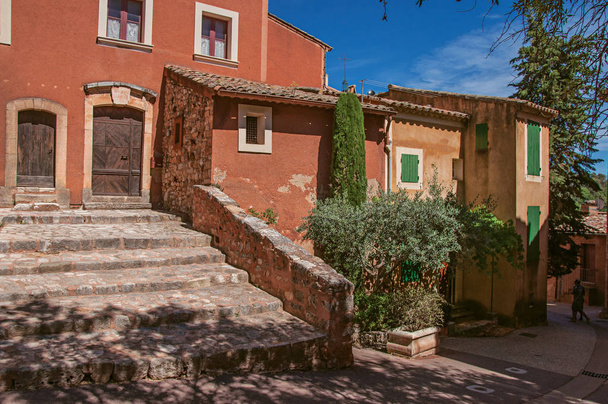 View of traditional colorful house in ocher and staircase, in the historic Roussillon. - Photo, image