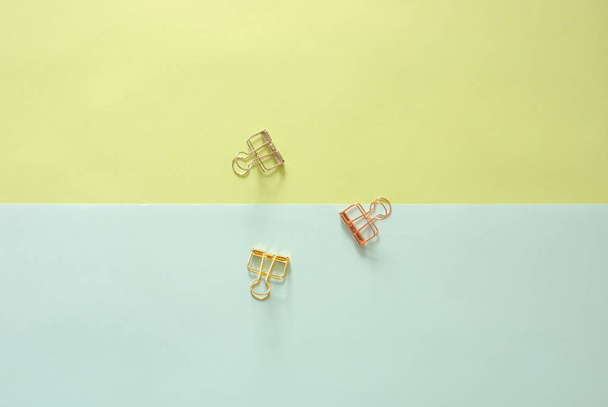 Minimal work space - Creative flat lay photo of workspace desk with paperclips on copy space pastel background. Top view , flat lay photography. - Photo, Image